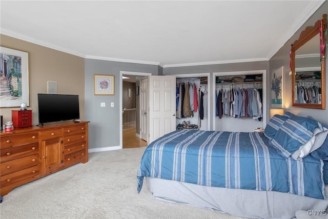 bedroom featuring multiple closets, carpet flooring, and crown molding