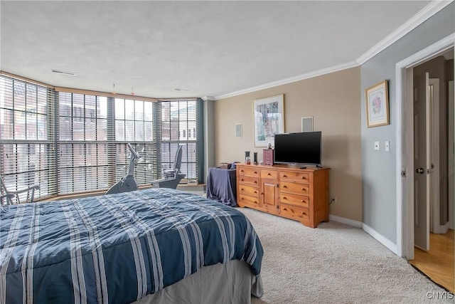 carpeted bedroom with ornamental molding