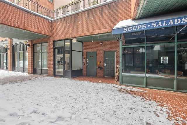 view of snow covered property entrance