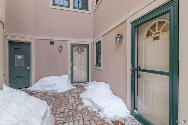 view of snow covered property entrance