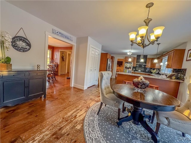 dining room featuring hardwood / wood-style floors and a chandelier