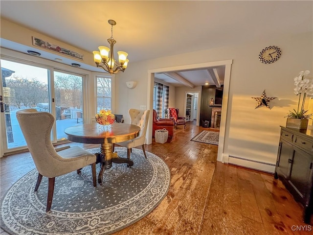 dining area featuring a baseboard heating unit, a notable chandelier, and dark hardwood / wood-style floors