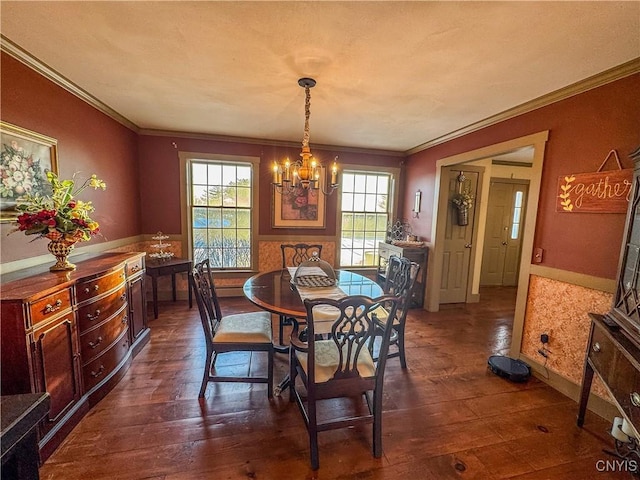 dining space featuring ornamental molding, dark hardwood / wood-style flooring, and a chandelier