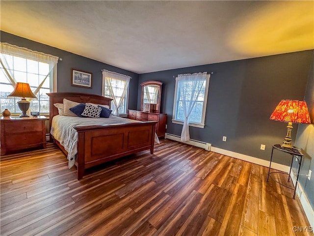 bedroom with baseboard heating and dark wood-type flooring