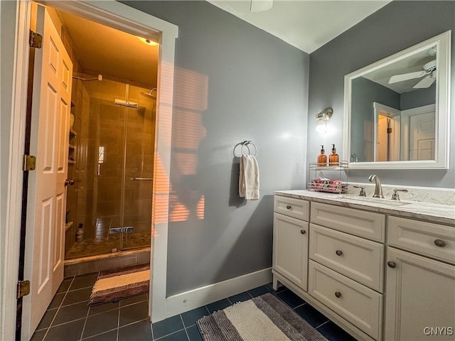 bathroom with vanity, a tile shower, tile patterned floors, and ceiling fan