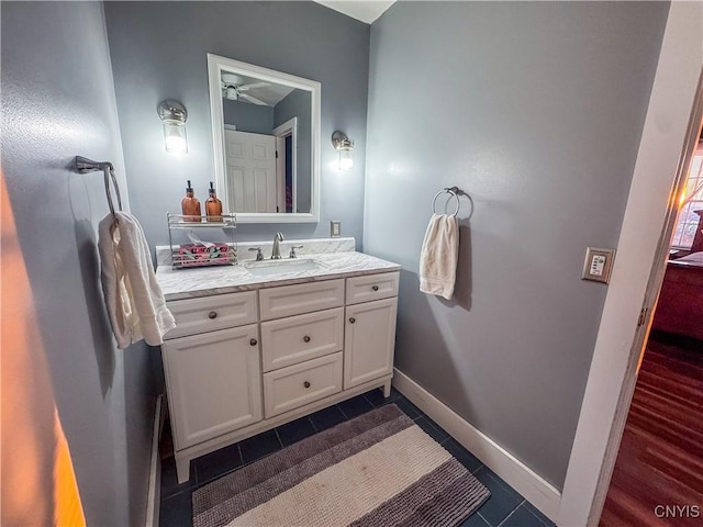 bathroom with ceiling fan, vanity, and tile patterned flooring