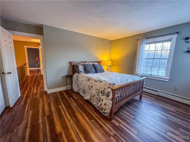 bedroom featuring a baseboard heating unit and dark wood-type flooring