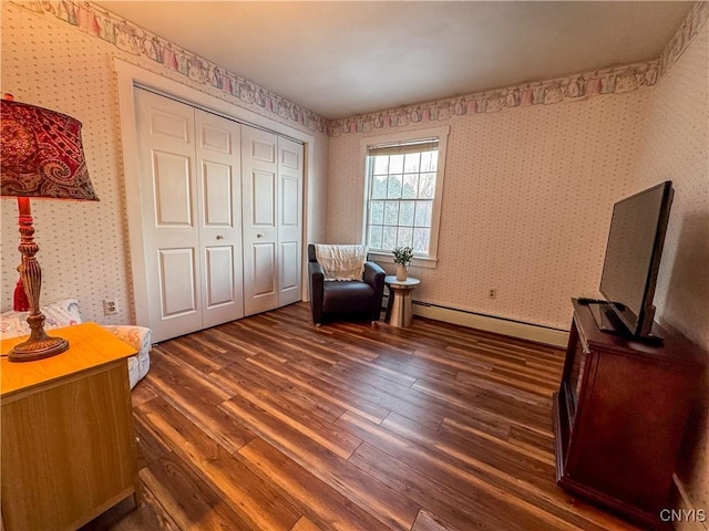 living area with a baseboard radiator and dark hardwood / wood-style floors