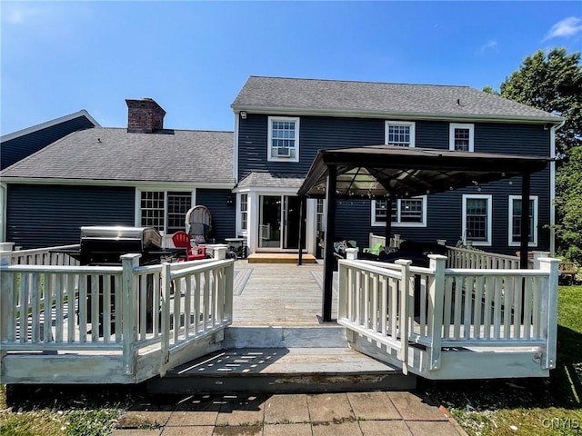 back of property with a gazebo and a deck