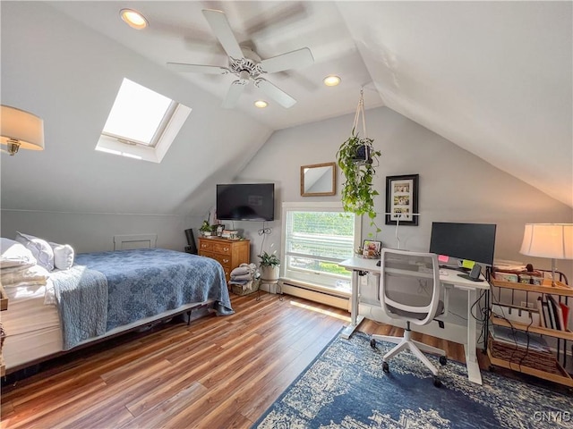 bedroom featuring wood-type flooring, lofted ceiling with skylight, ceiling fan, and a baseboard radiator