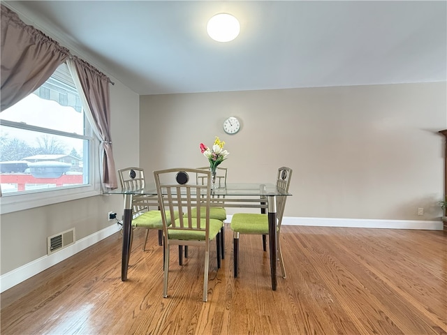 dining space with light hardwood / wood-style floors