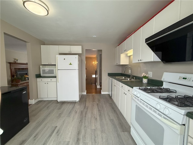 kitchen with sink, white cabinets, white appliances, and light hardwood / wood-style flooring