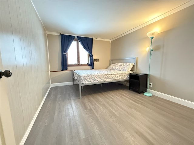 unfurnished bedroom featuring hardwood / wood-style flooring and ornamental molding