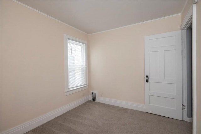 carpeted spare room featuring ornamental molding