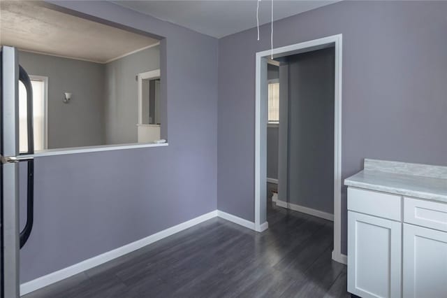 unfurnished dining area with dark hardwood / wood-style floors