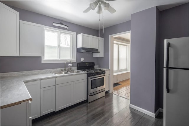 kitchen featuring dark wood-type flooring, stainless steel appliances, sink, and white cabinets