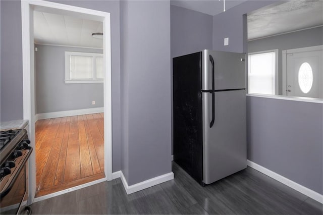 kitchen featuring stainless steel appliances and dark hardwood / wood-style floors