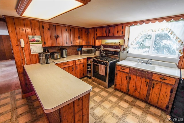 kitchen featuring stainless steel appliances, sink, and decorative backsplash