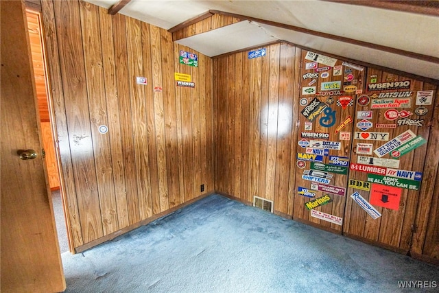 unfurnished room featuring carpet flooring, lofted ceiling, and wooden walls