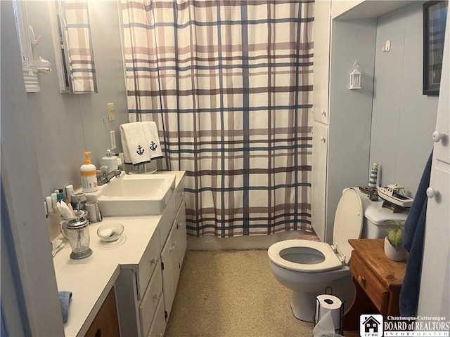 bathroom featuring vanity, toilet, and walk in shower