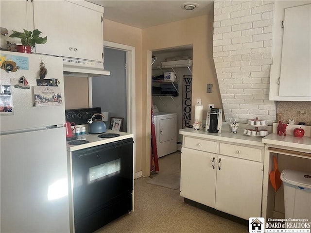 kitchen featuring black range with electric cooktop, washer and dryer, white cabinets, and white fridge