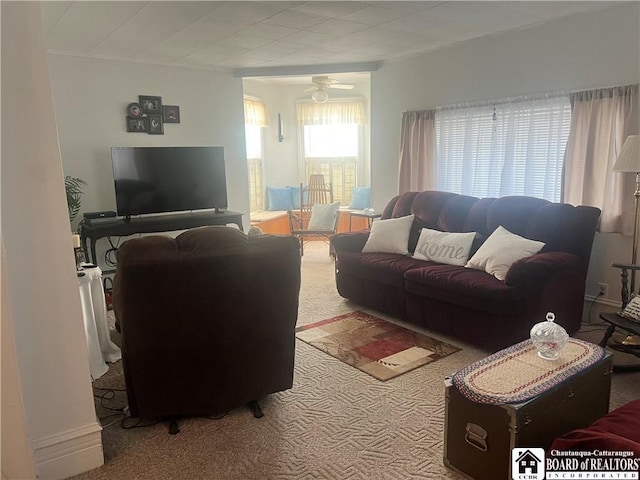 carpeted living room with ceiling fan