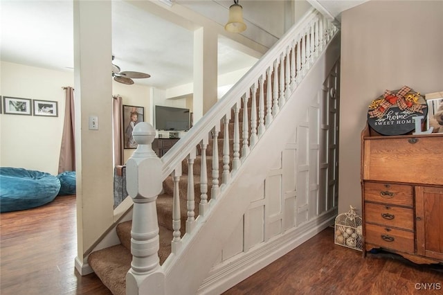 stairway featuring hardwood / wood-style floors and ceiling fan