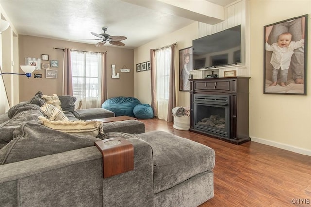 living room featuring hardwood / wood-style floors and ceiling fan