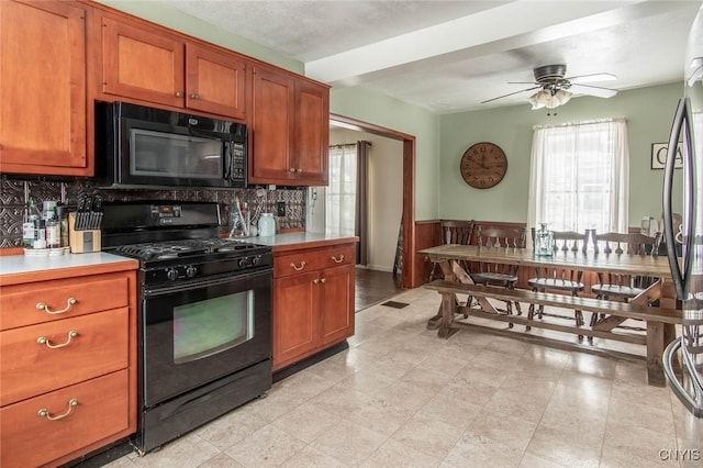 kitchen featuring backsplash, ceiling fan, and black appliances