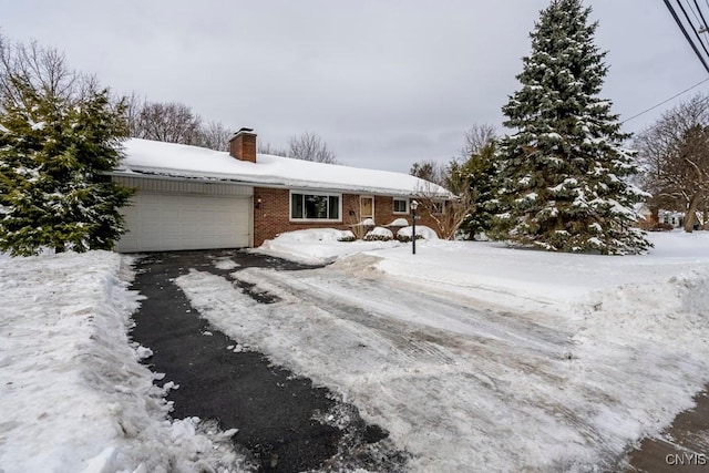 view of snowy exterior with a garage