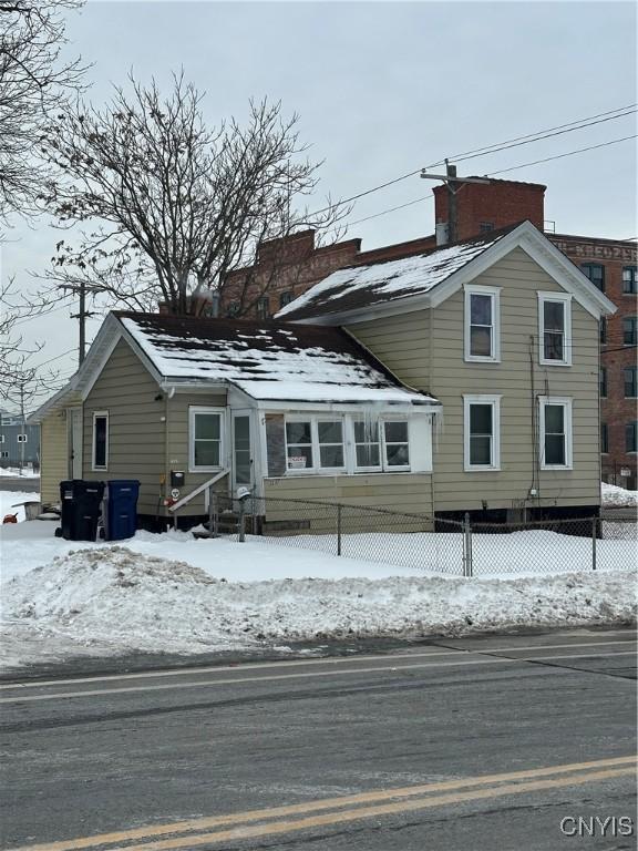 view of snow covered rear of property