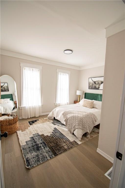 bedroom featuring crown molding and hardwood / wood-style flooring