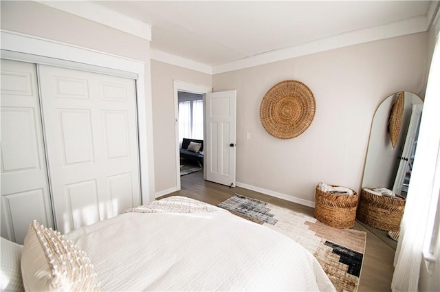 bedroom with crown molding, hardwood / wood-style floors, and a closet