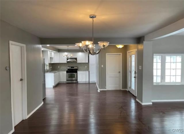 807 Utica Rd, Utica, NY 13502 - kitchen featuring appliances with stainless steel finishes, white cabinetry, an inviting chandelier, tasteful backsplash, and decorative light fixtures