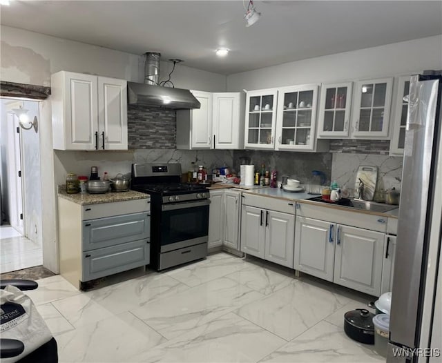 kitchen featuring sink, white cabinetry, stainless steel appliances, range hood, and backsplash