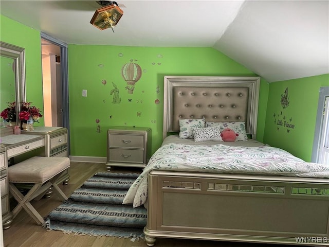 bedroom with wood-type flooring and lofted ceiling