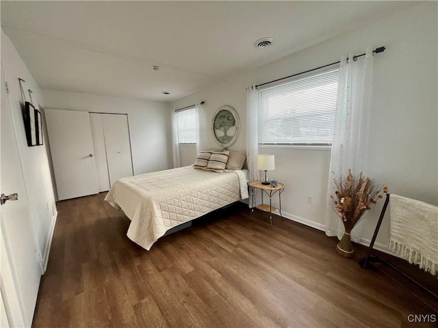 bedroom with dark wood-type flooring