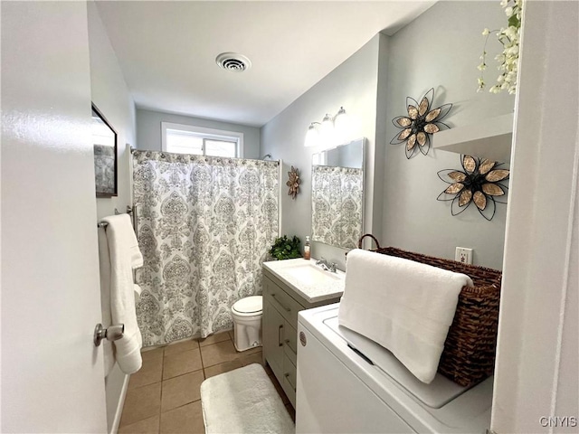 bathroom with a shower with curtain, vanity, tile patterned floors, and toilet