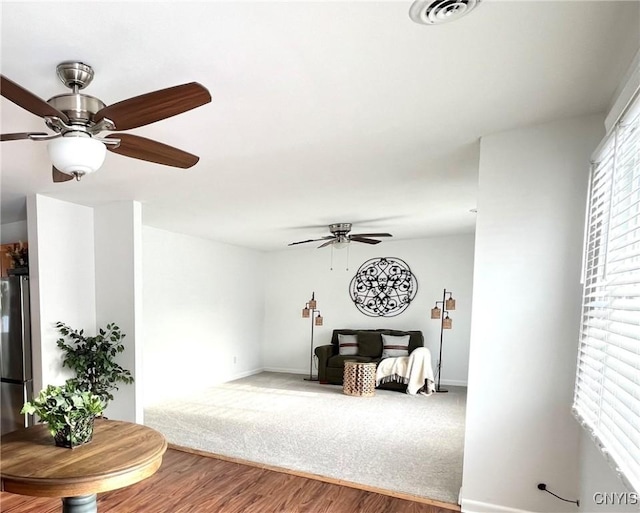 bedroom with stainless steel refrigerator, ceiling fan, and hardwood / wood-style floors