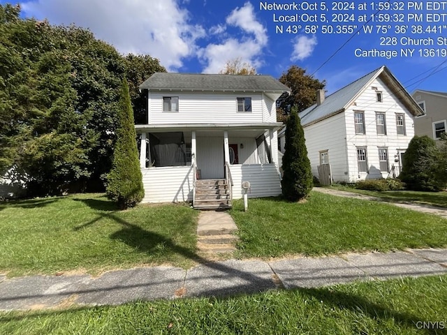 view of front of property with a front yard and covered porch