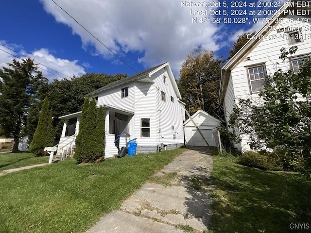 view of property exterior with an outbuilding, a yard, and a garage