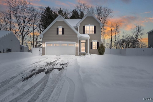 traditional home featuring a garage and fence