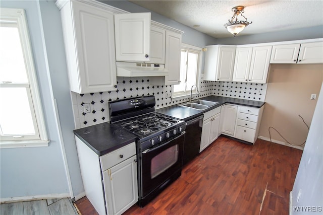 kitchen with sink, backsplash, white cabinets, dark hardwood / wood-style flooring, and black appliances