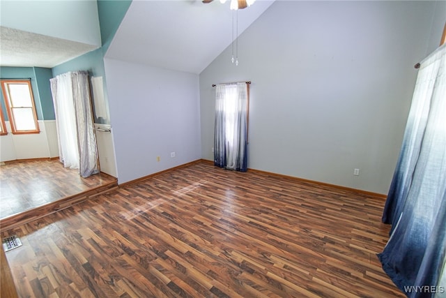 unfurnished room with dark wood-type flooring, ceiling fan, and high vaulted ceiling