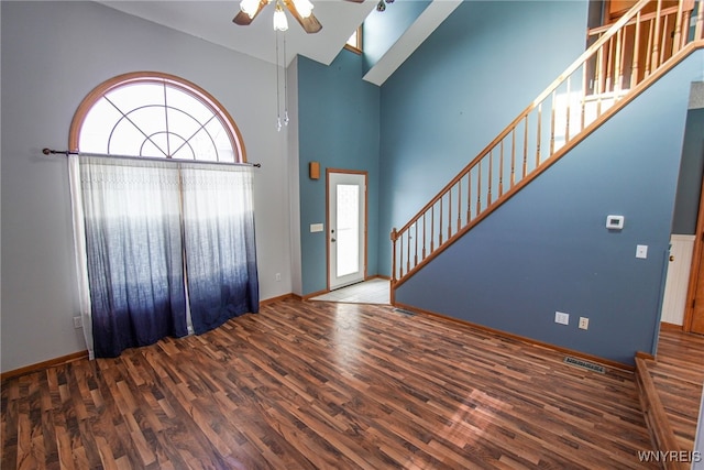 foyer with high vaulted ceiling, dark hardwood / wood-style floors, and ceiling fan