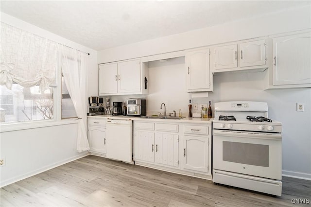 kitchen with white cabinetry, sink, white appliances, and light wood-type flooring