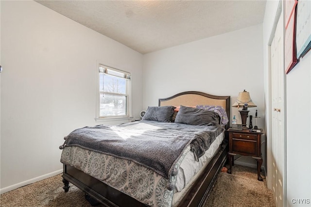 carpeted bedroom featuring a textured ceiling