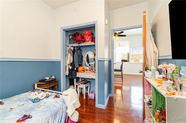 bedroom featuring dark hardwood / wood-style flooring and a closet