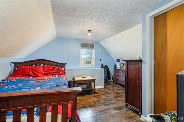 bedroom with cooling unit, vaulted ceiling, dark hardwood / wood-style floors, and a textured ceiling