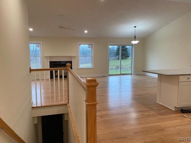 stairs featuring hardwood / wood-style floors and ceiling fan